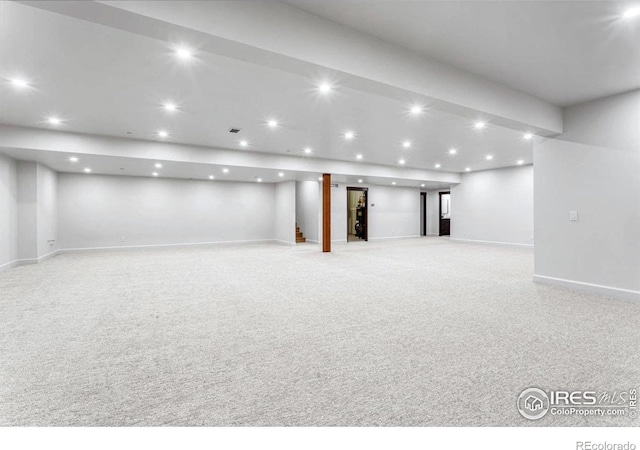 basement featuring light carpet