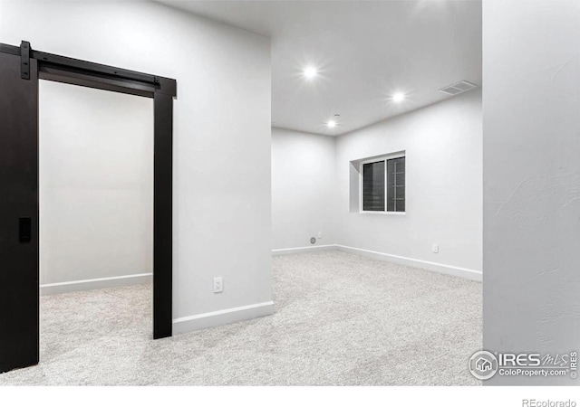 unfurnished room featuring light colored carpet