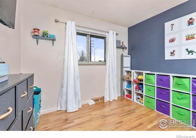 playroom featuring light wood-type flooring