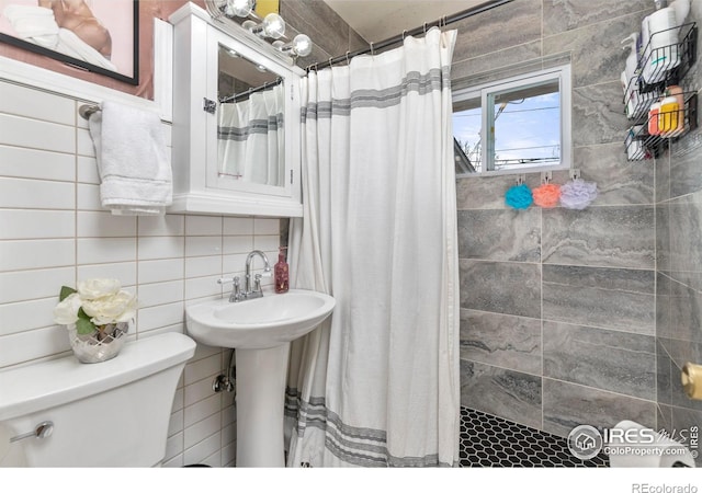 bathroom with walk in shower, backsplash, toilet, and tile walls