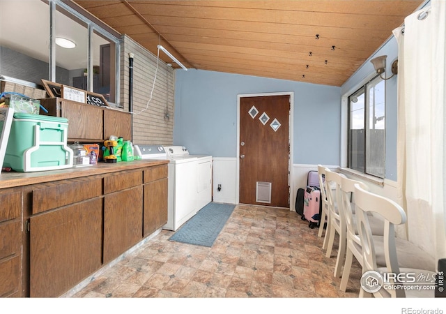 washroom featuring cabinets, washer and clothes dryer, and wooden ceiling