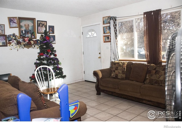 living room featuring light tile patterned flooring and a textured ceiling