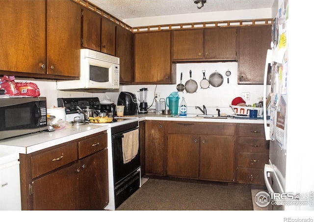 kitchen with sink, white appliances, a textured ceiling, and dark brown cabinetry