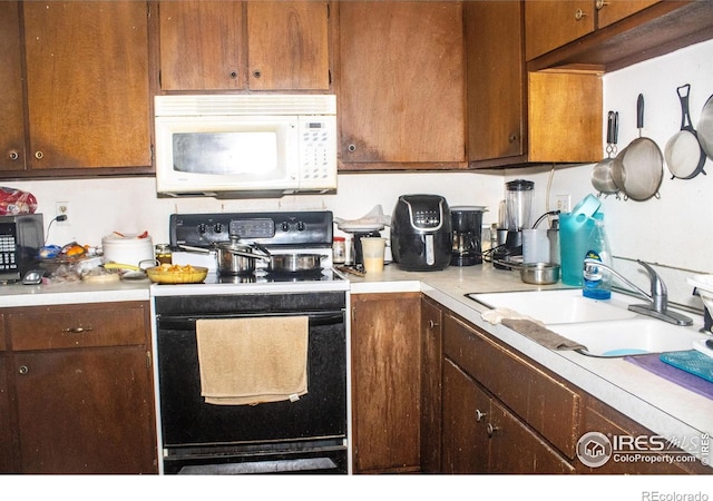 kitchen featuring sink and black appliances