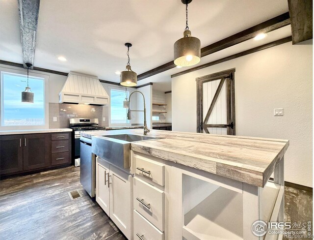 kitchen with decorative backsplash, pendant lighting, dark hardwood / wood-style floors, and white cabinetry