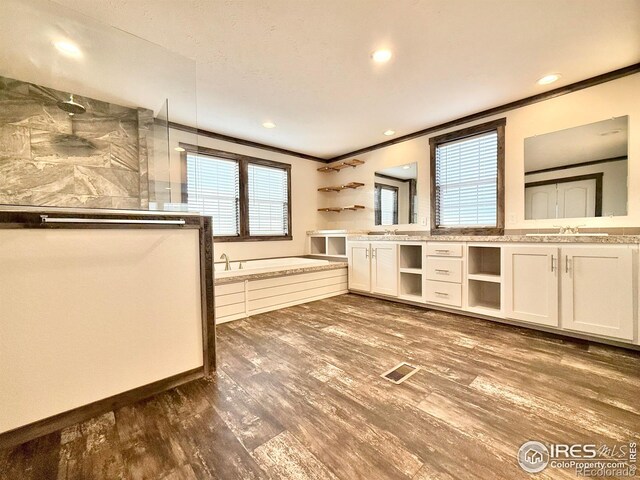 kitchen featuring sink, white cabinets, ornamental molding, and hardwood / wood-style flooring