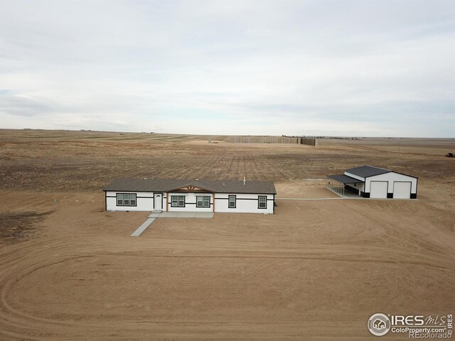 birds eye view of property with a rural view