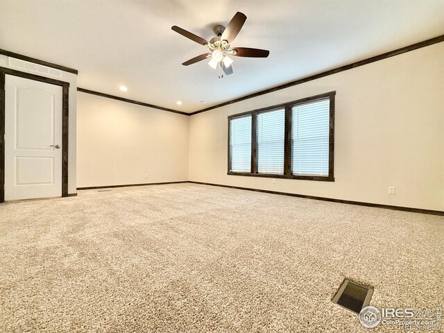 spare room with carpet flooring, ceiling fan, and crown molding