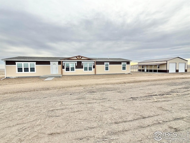 view of front of house with an outdoor structure and a garage