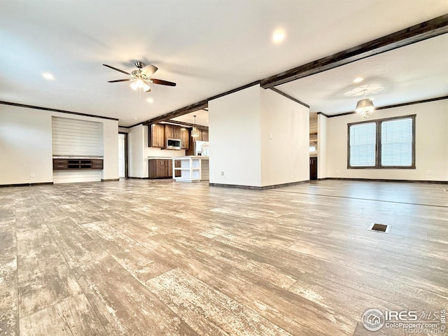 unfurnished living room with beam ceiling, ceiling fan, and light hardwood / wood-style floors