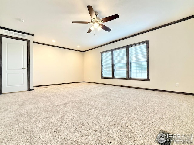 empty room featuring carpet floors, ceiling fan, and crown molding