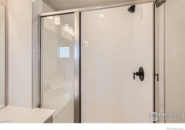 bathroom with a shower with door