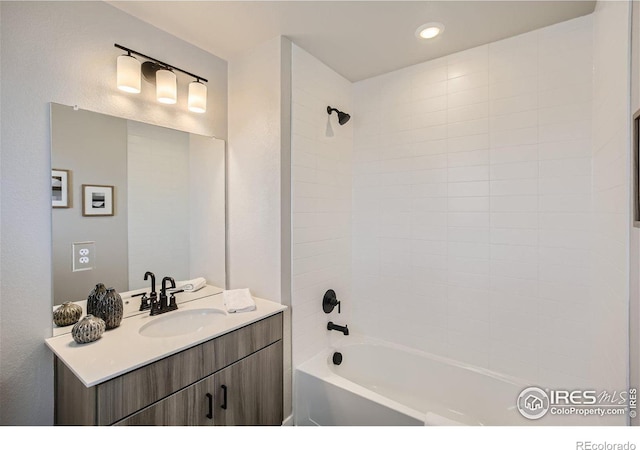 bathroom featuring vanity and tiled shower / bath combo