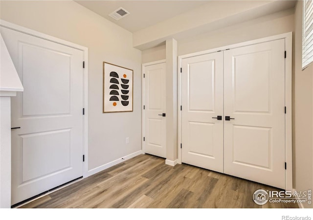 unfurnished bedroom featuring a closet and light hardwood / wood-style flooring