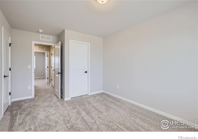 unfurnished bedroom featuring light colored carpet