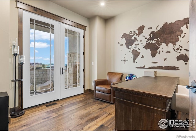 home office with french doors and wood-type flooring