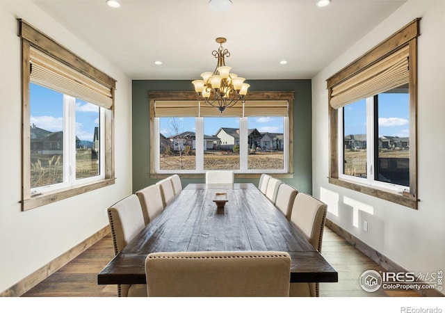 dining area with a chandelier and hardwood / wood-style flooring