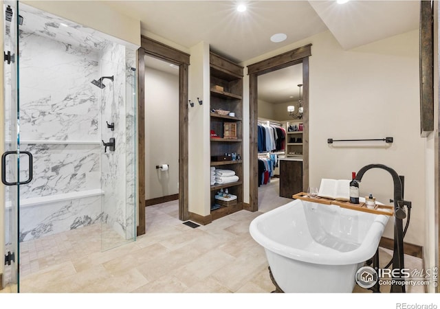 bathroom featuring a chandelier and independent shower and bath