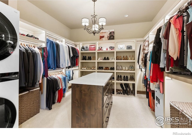 spacious closet with light colored carpet and an inviting chandelier