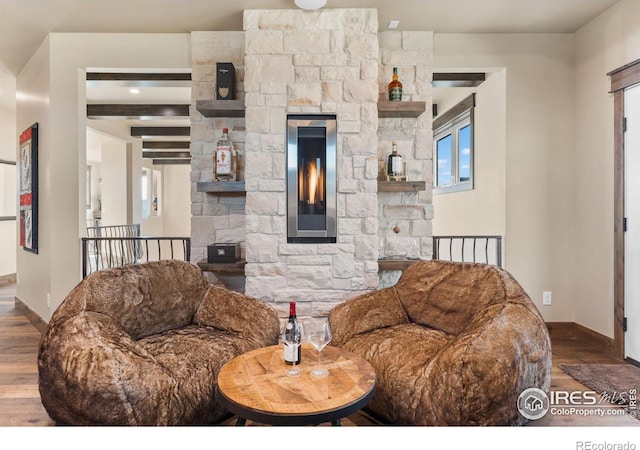 living room featuring beam ceiling and hardwood / wood-style floors