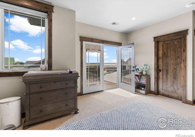 bedroom featuring access to outside, light carpet, and french doors