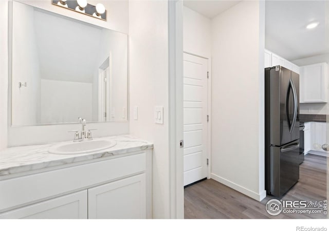 bathroom featuring vanity and hardwood / wood-style floors