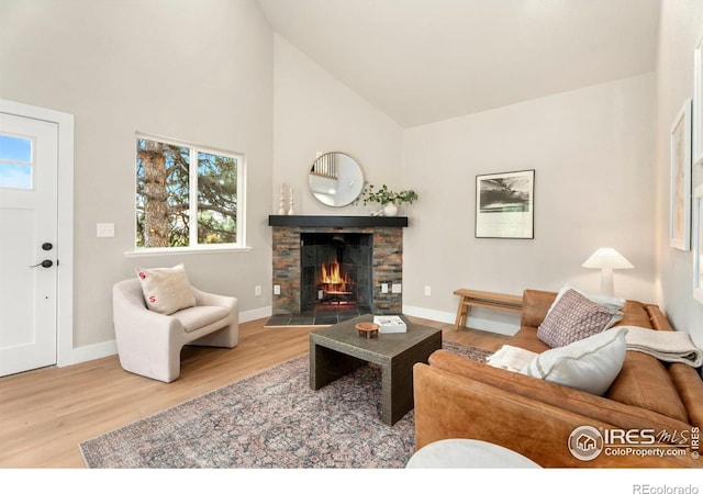 living room with plenty of natural light, a fireplace, and hardwood / wood-style flooring