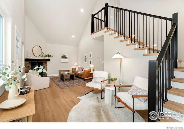 living room with a high ceiling and hardwood / wood-style flooring