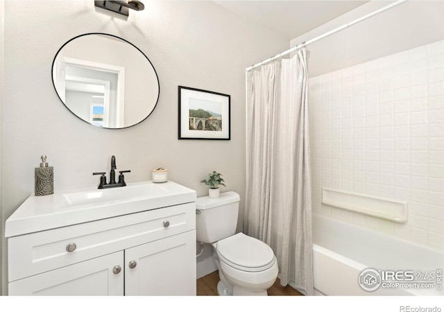 full bathroom with shower / tub combo with curtain, vanity, and toilet