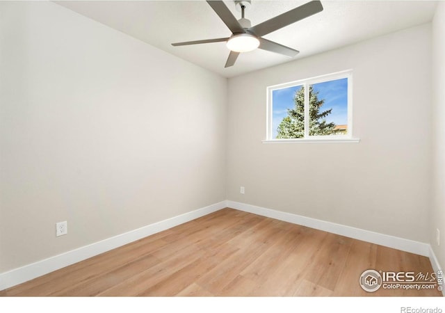 spare room with light wood-type flooring and ceiling fan