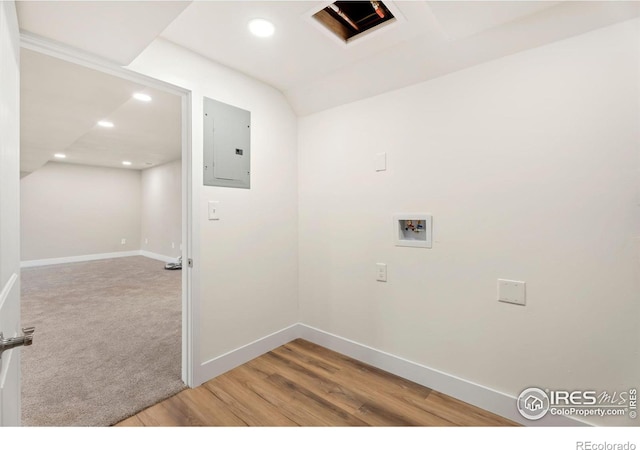 laundry room with electric panel, hardwood / wood-style flooring, and hookup for a washing machine