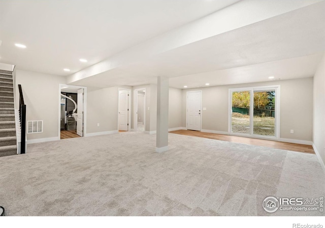 basement featuring light colored carpet