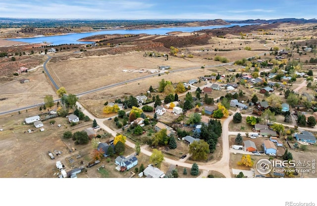 birds eye view of property featuring a water and mountain view