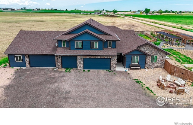 craftsman-style house featuring a rural view and a garage