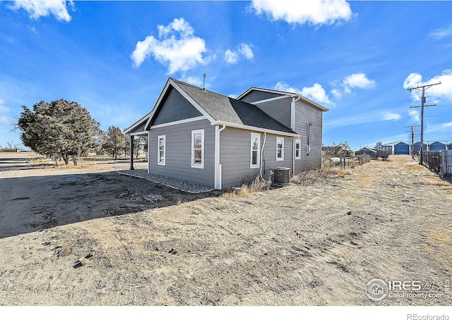 view of side of property featuring central AC