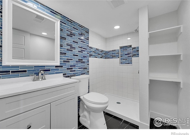 bathroom with a tile shower, decorative backsplash, vanity, and toilet