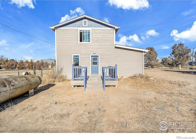 rear view of house with a wooden deck