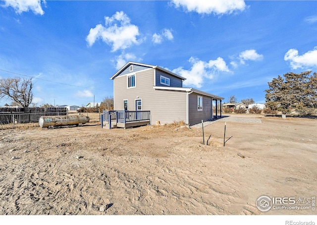 back of property with a wooden deck