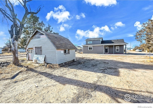 rear view of property with an outbuilding