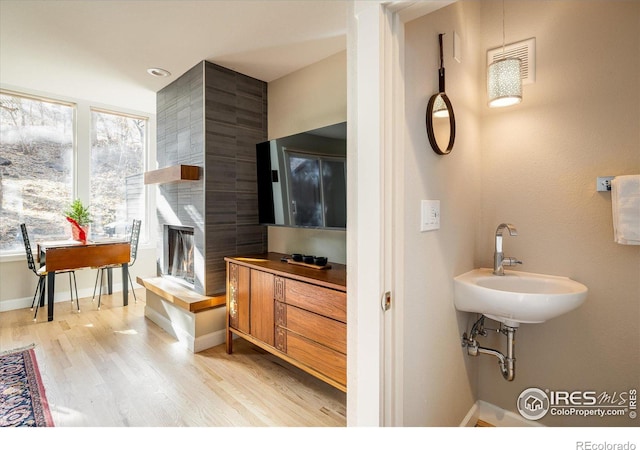 bathroom with hardwood / wood-style flooring, plenty of natural light, and sink