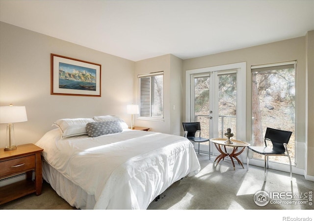 bedroom with carpet floors, access to outside, and french doors