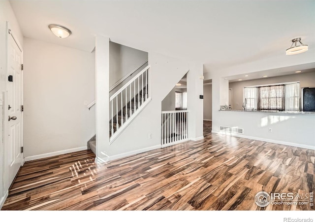 unfurnished living room with hardwood / wood-style flooring