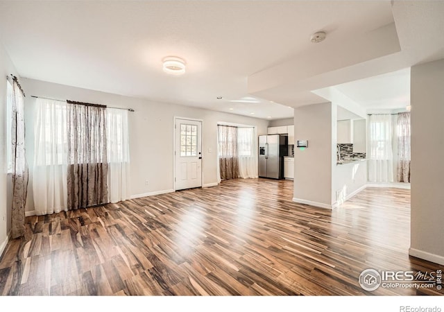 unfurnished living room with hardwood / wood-style floors