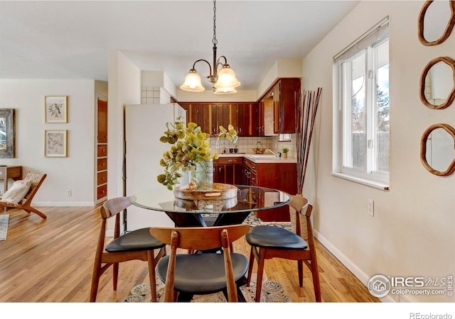 dining room featuring light hardwood / wood-style floors and an inviting chandelier