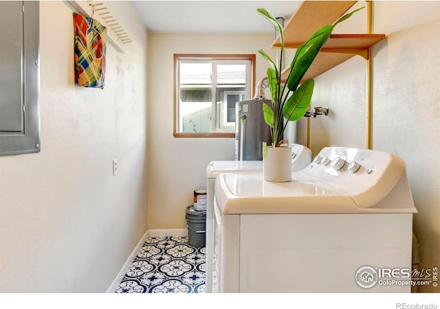 laundry room with tile patterned flooring, gas water heater, and washing machine and clothes dryer