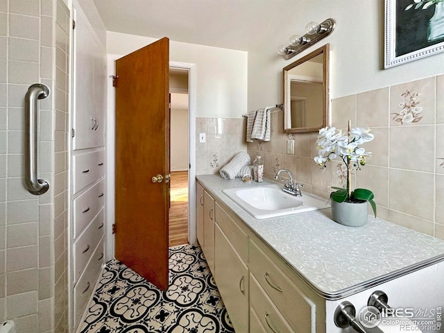 bathroom featuring vanity, tile patterned floors, and tile walls