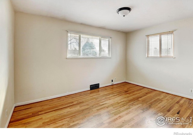 unfurnished room with light wood-type flooring