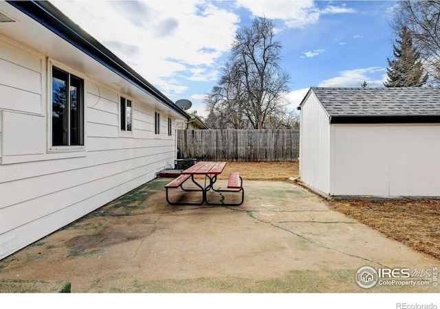 view of patio featuring a shed