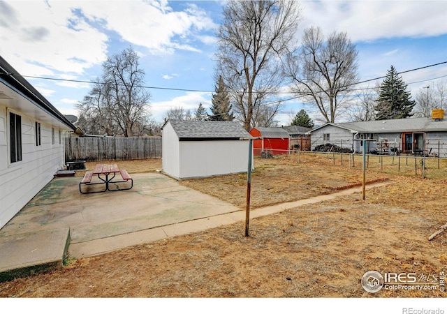 view of yard with a storage unit and a patio