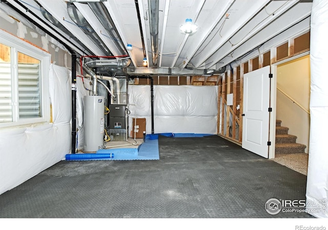 unfinished basement featuring stairway, carpet flooring, and water heater